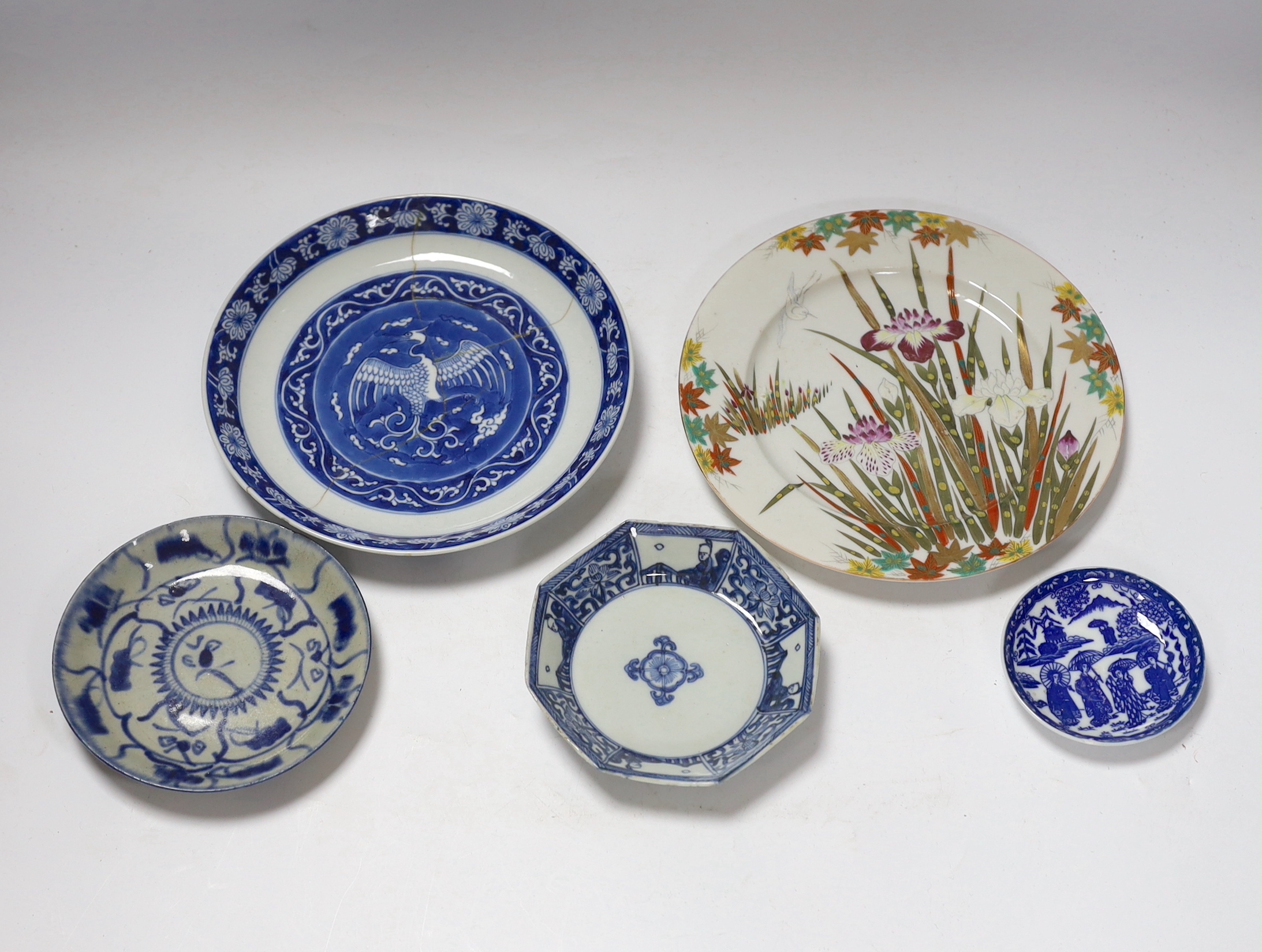 A group of 18th century Chinese porcelain plates and saucers, mostly blue and white and an octagonal famille rose example, together with three Japanese dishes, largest 27cm in diameter